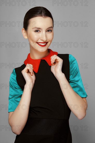 Pretty young fashion model with tan skin and red mat lips. Beauty shoot
