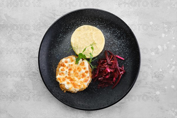 Kiev citlet with mashed potato and pickled beetroot on a plate