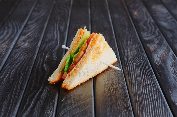 Appetizer for reception. Mini club sandwich on wooden table