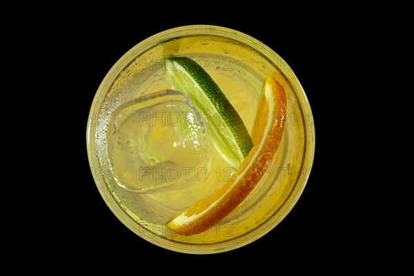 Cold Lemon cocktail with a sparkling wine with ice cubes in take away glass isolated on black