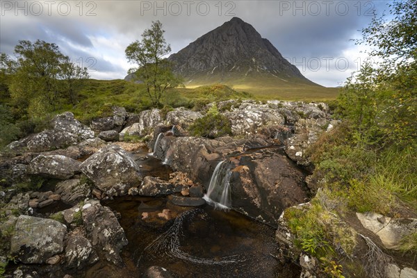 Waterfalls in front of mountain range Buachaille Etive Mor