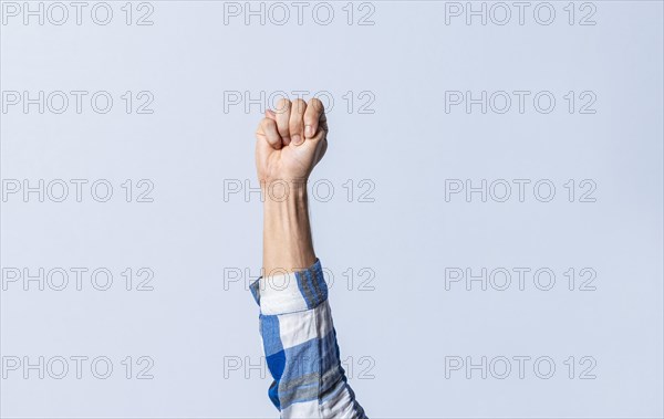 Hand gesturing the letter M in sign language on an isolated background. Man's hand gesturing the letter M of the alphabet isolated. Letter M of the alphabet in sign language