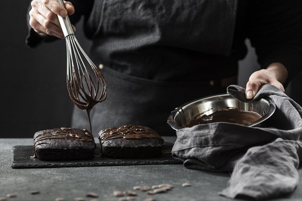 Front view pastry chef preparing cake with chocolate