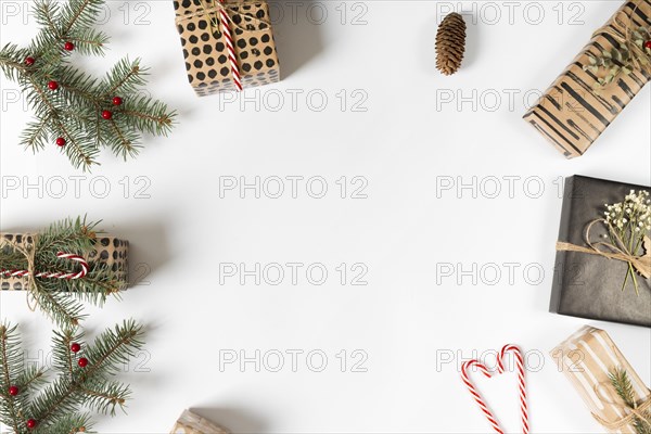 Gift boxes with green branches candy canes