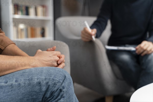 Woman holding hands together talking with counselor. Resolution and high quality beautiful photo