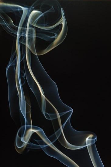 Trajectory of incense smoke in the air showing different shapes. France