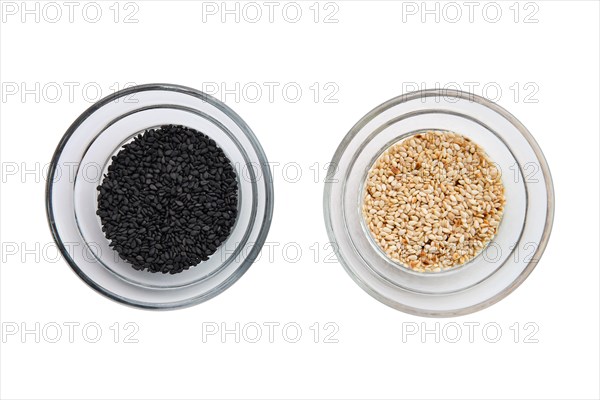 Top view of sesame seeds in a little bowls isolated on white background