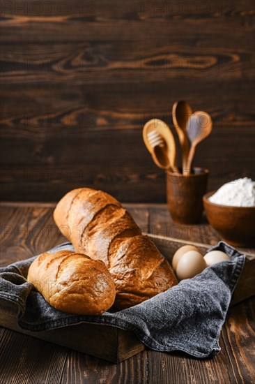 Fresh loaf of wheat bread on wooden cutting board