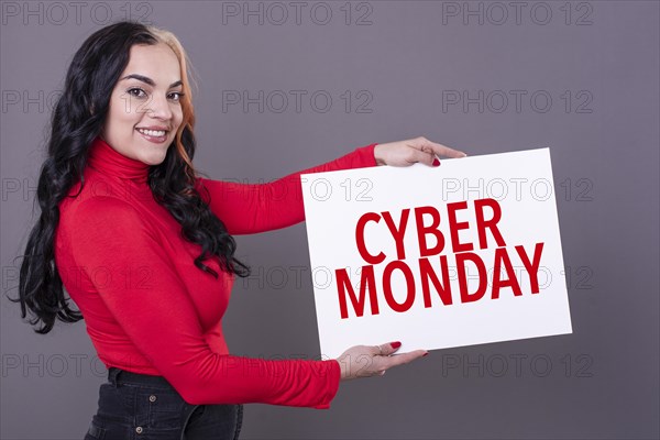 Beautiful woman holding a Cyber Monday sign. Commercial concept. Commerce