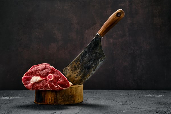 Raw fresh lamb leg and butcher cleaver