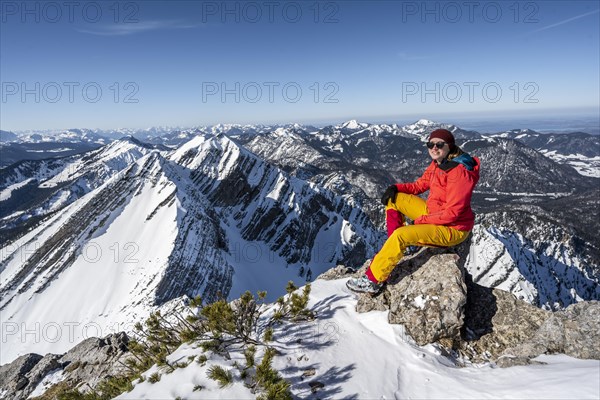 Ski tourer sitting on a rock