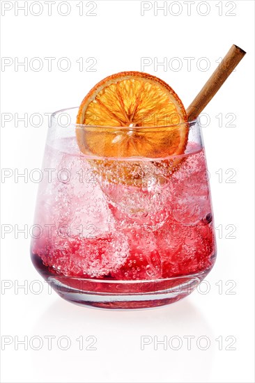 Glass of spicy tonic with ice and strawberry syrup isolated on white