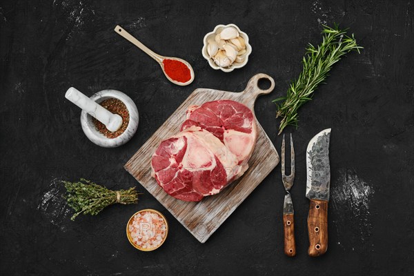 Overhead view of raw beef ossobuco steak with spices