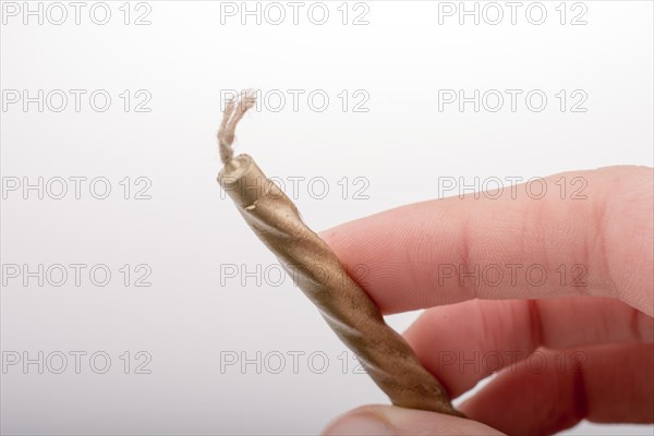 Gold colorl candle stick in hand on a white background
