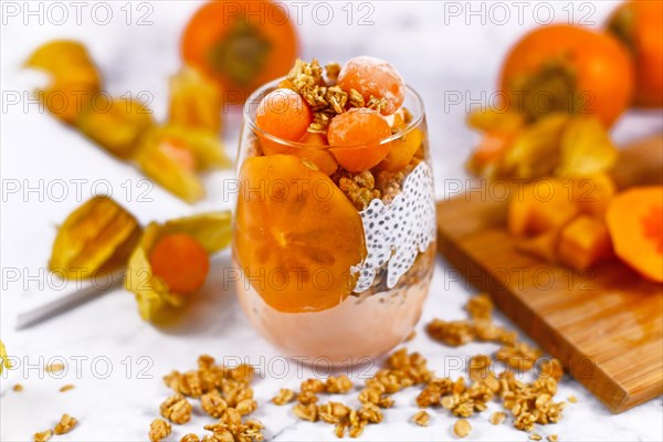 Healthy layered smoothie in glass with chia sees pudding