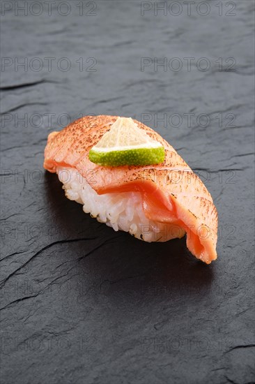 Sushi with seared salmon on slate plate
