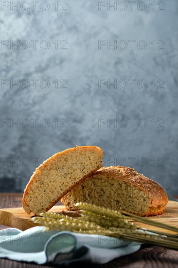 Close up view of homemade wheat bread on wooden cutting board