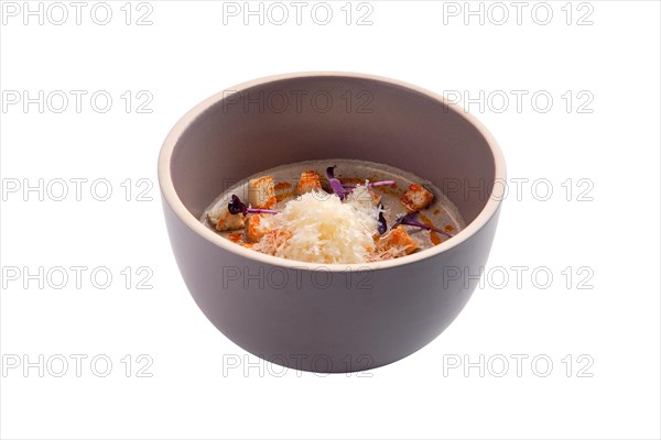 Mushroom soup puree with sheese and croutons isolated on white background