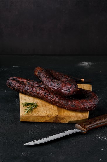 Smoked beef sausage on cutting board