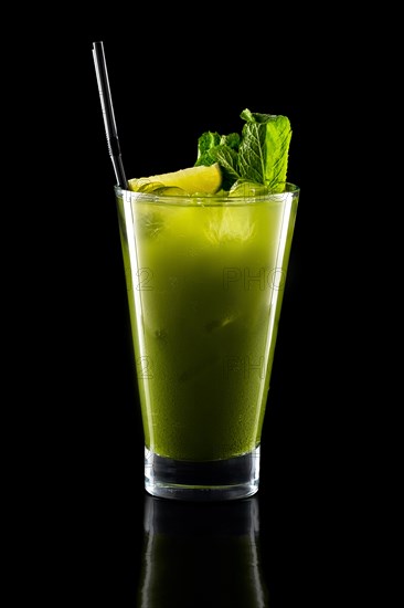 Glass of fresh cold smoothies with straw isolated on black background