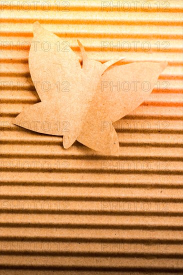 Woman figurine placed beside a paper butterfly shape