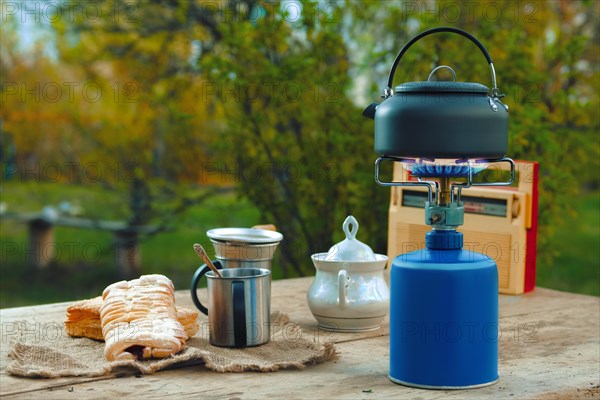 Snack outdoor in summer evening. Camping kettle