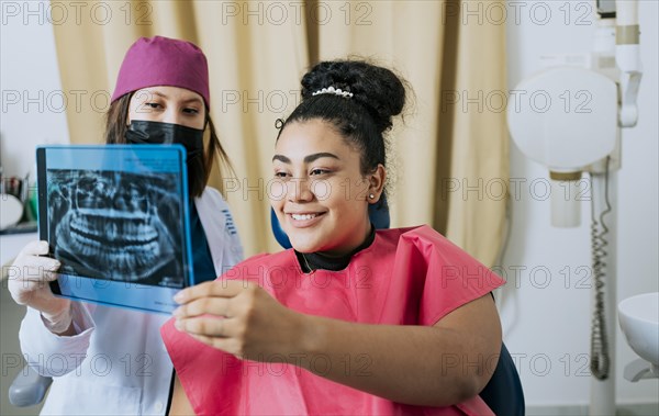 Patient looking at x-ray with dentist