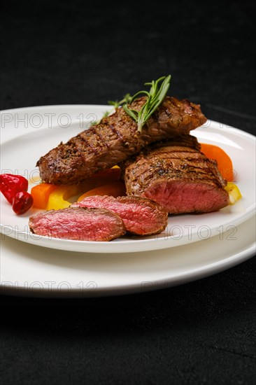 Grilled lamb steaks cut on slices on a plate