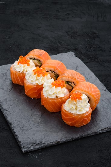 Rolls with salmon and cream cheese with caviar