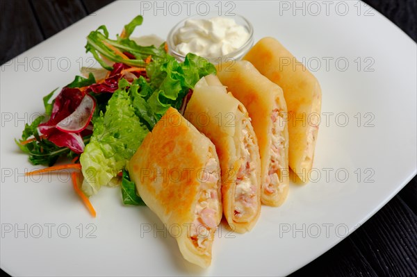 Pancakes with ham and salad