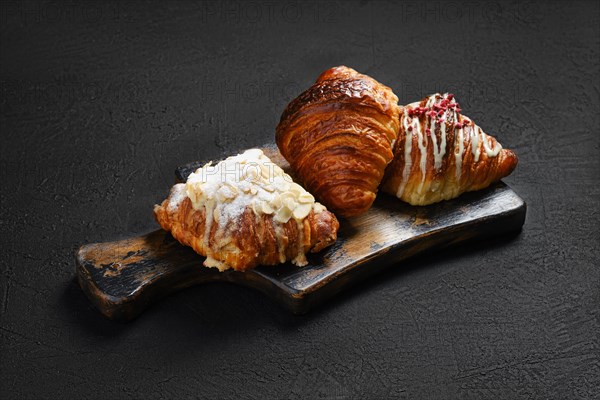 Assortment of crispy croissants on serving board