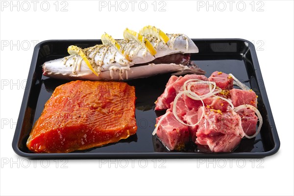 Marinated varieties of meat and fish ready for grilling isolated on white background