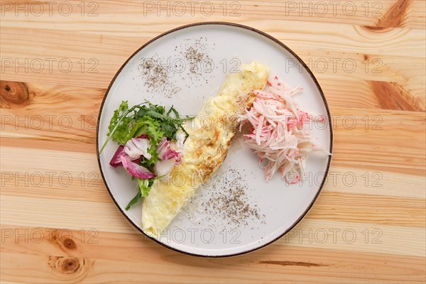 Omelette with crab meat and salad