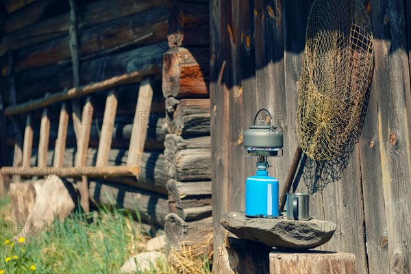 Boiling water in hiking kettle. Outdoor cooking equipment