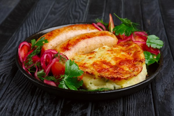 Fried homemade sausage with fried mashed potato