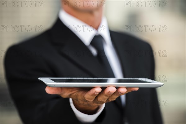 Close up businessman holding tablet hand