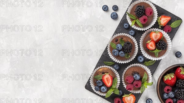 Flat lay tasty muffin with forest fruit