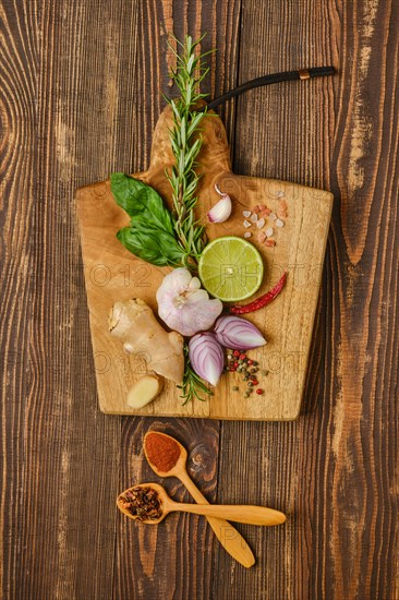 Composition with different spice and seasonings for cooking on wooden cutting board