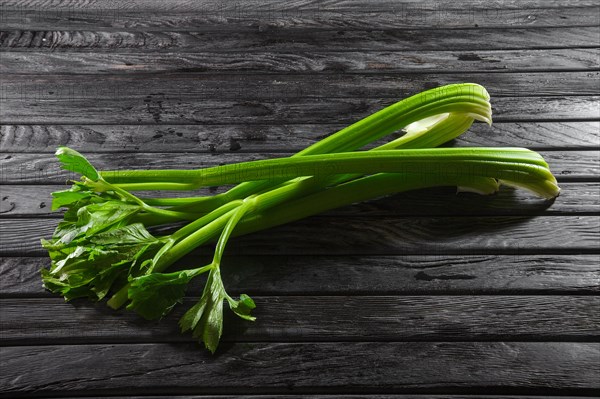 Top view of celery sterns on wooden table