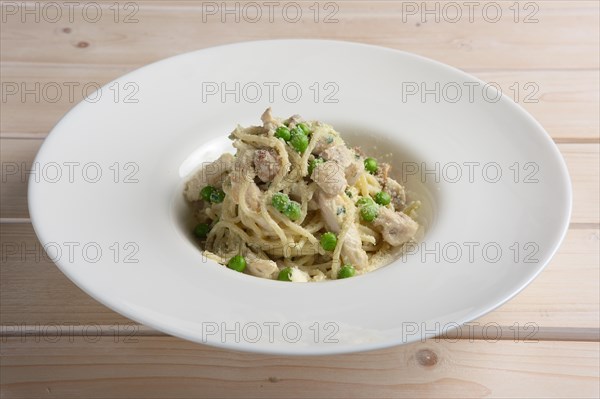 Plate of spaghetti with green pease