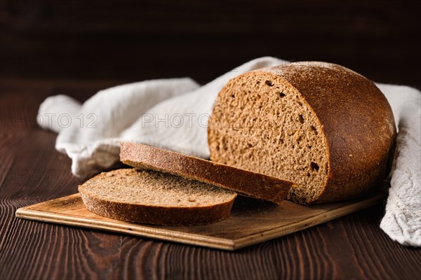 Rue brown bread on cutting board on the table