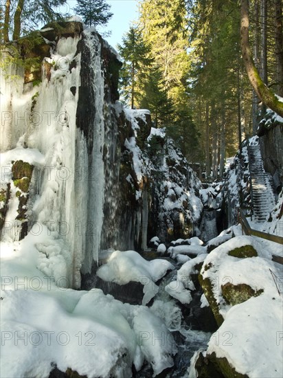 Waterfall and hiking trail in the gorge of the Menzenschwander Alb