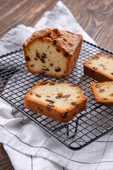 Fresh biscuit cake with raisins on the table closeup