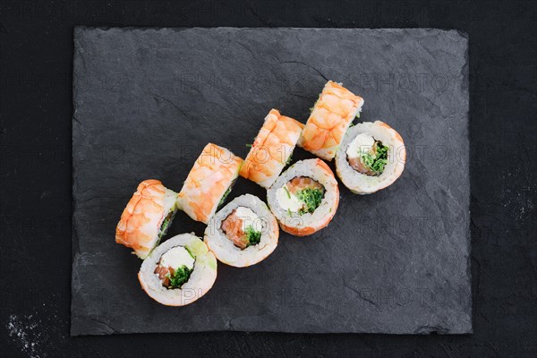 Rolls with shrimp and cream cheese on slate plate