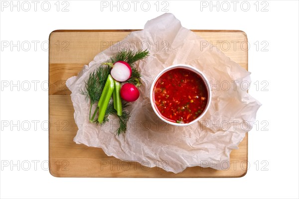 Top view of plate with celery and radish soup isolated on white
