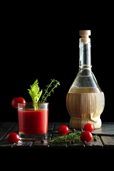 Rustic cocktail Bloody Mary with ingredient on wooden table