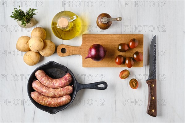 Top view of homemade sausage stuffed with beef and turkey meat in frying pan