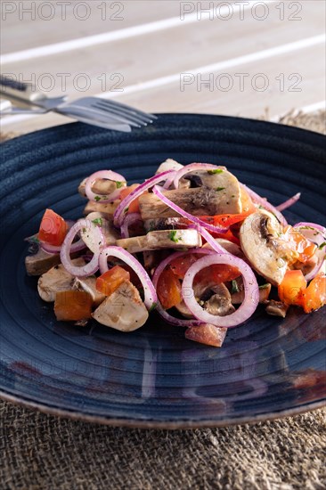 Lightly fried champignon with fresh onion rings and tomato. Snack for drink