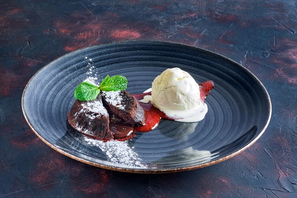 Chocolate fondant with ice cream and strawberry jam