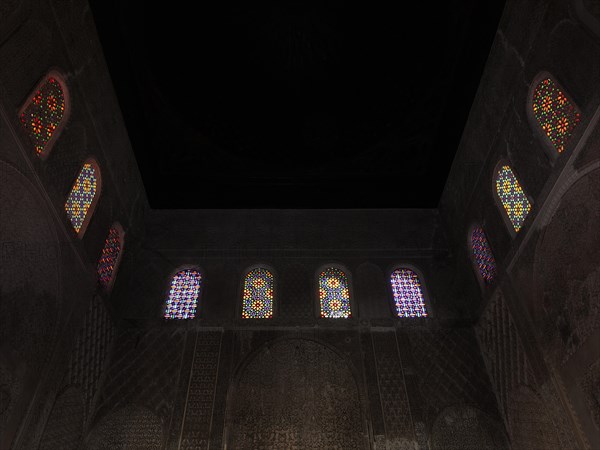 Colourful mosaic windows in the dark